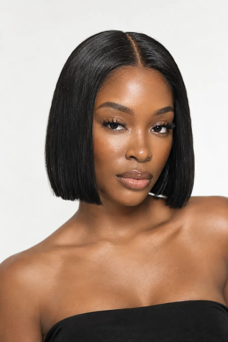 Woman with a sleek, blunt chin-length bob with a middle part