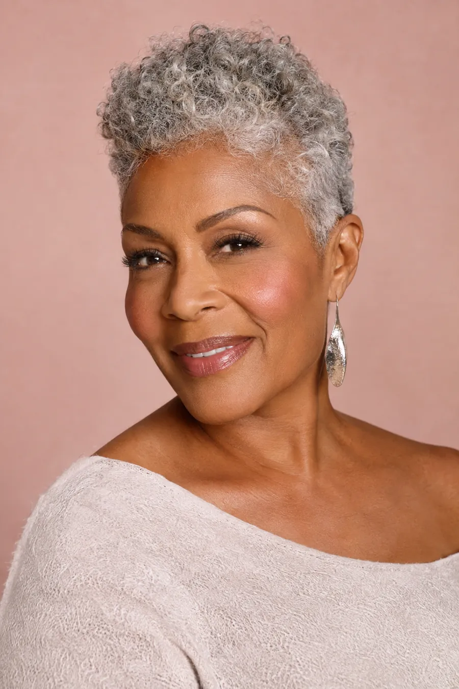 Smiling woman in her sixties with a short silver tapered natural cut